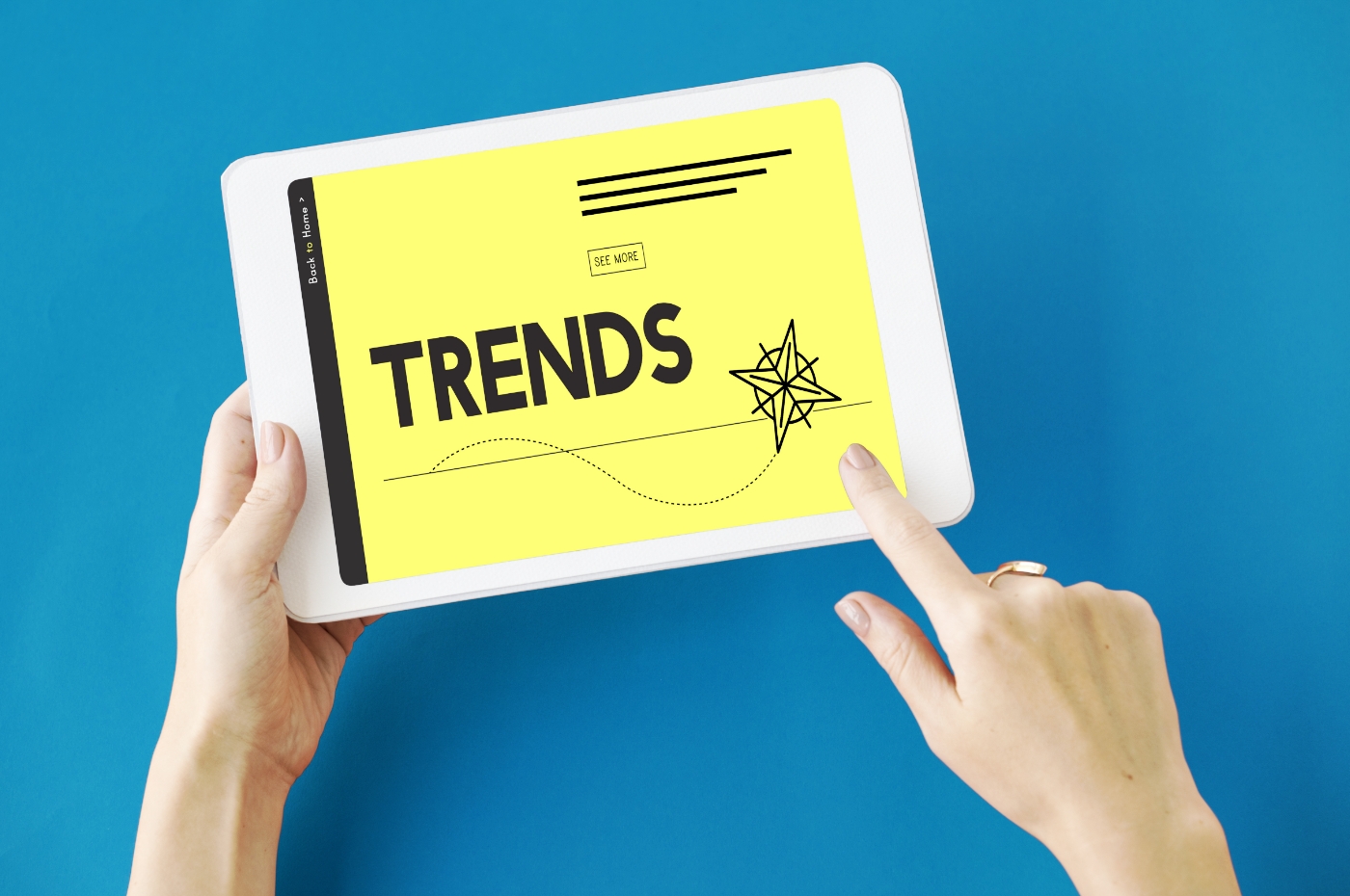 Hands holding a tablet, "trends" appears on the screen. Outsourcing market trends article