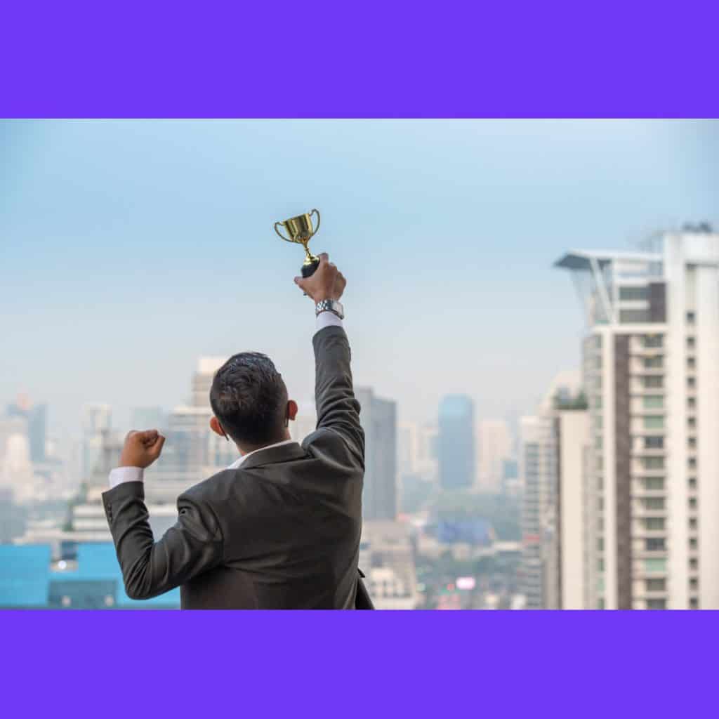 businessman-celebrating-with-trophy