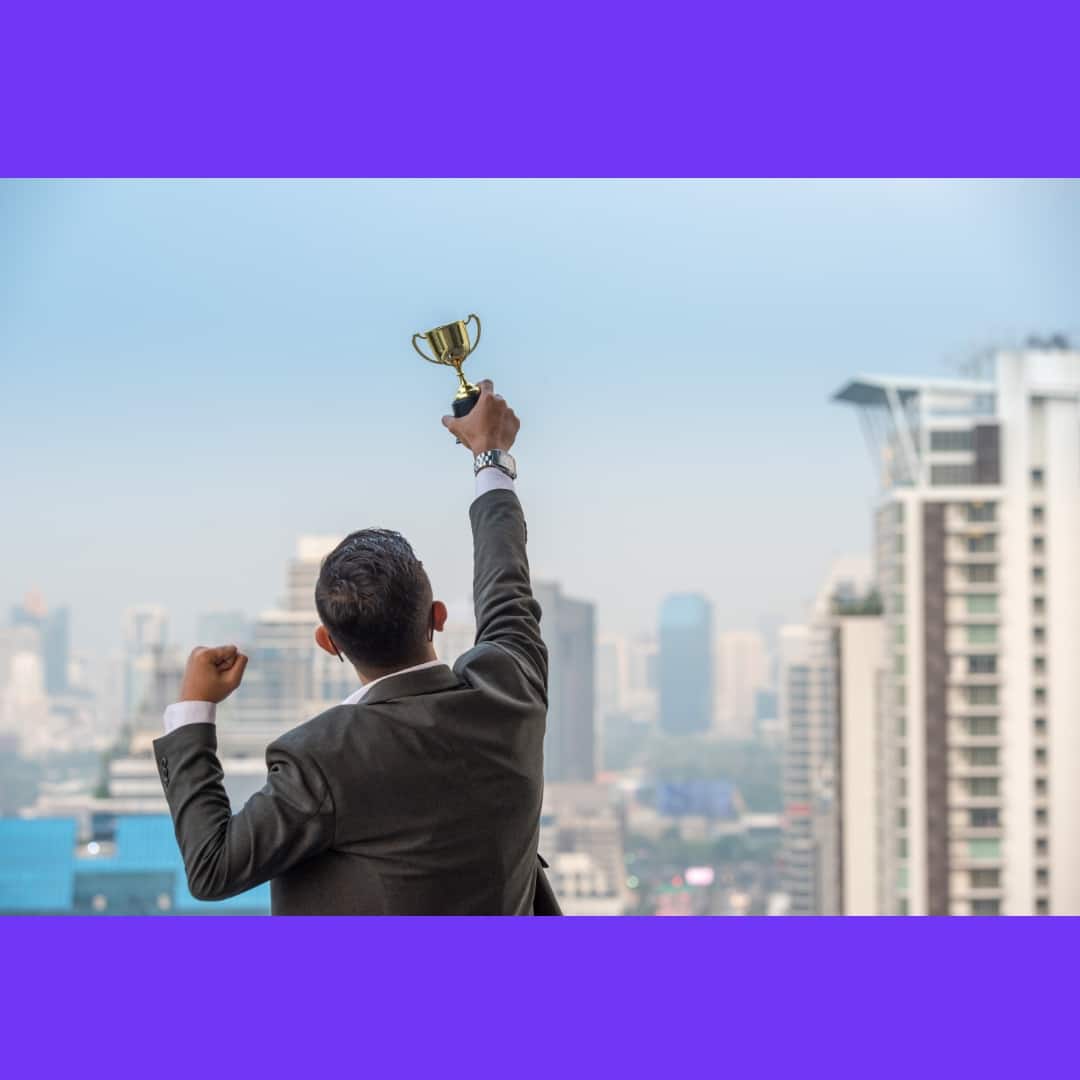 businessman-celebrating-with-trophy